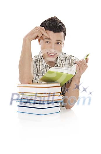 Boy behind a pile of books isolated on white