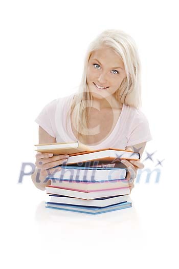 Girl behind a pile of books isolated on white