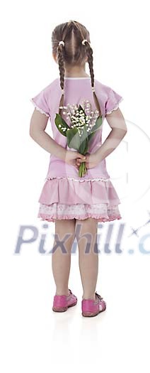 Little girl hiding a bouquet of flowers behind her back