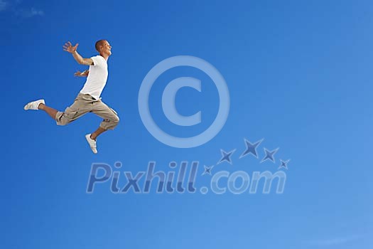 Man jumping against a blue sky