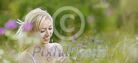 Bautiful woman in meadow surrounded by blurred meadow flowers Bautiful woman in meadow surrounded by blurred meadow flowers