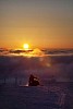 Snowmobile riding at the sunset