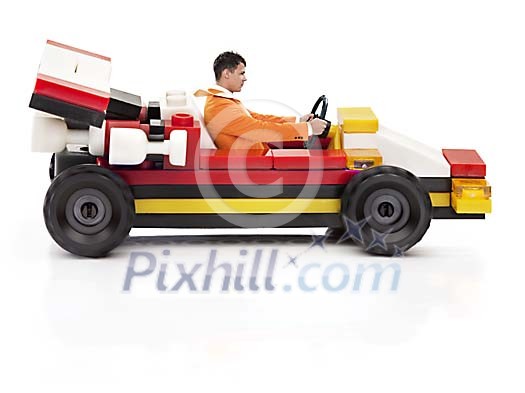 Adult man driving a toy race-car