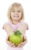 Young girl offering a fresh apple to camera