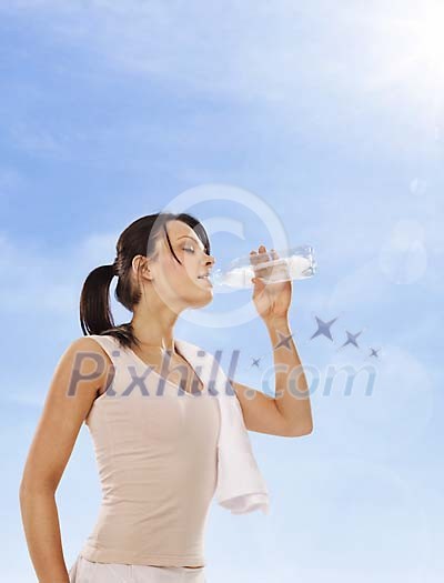 Sporty girl drinking water from bottle