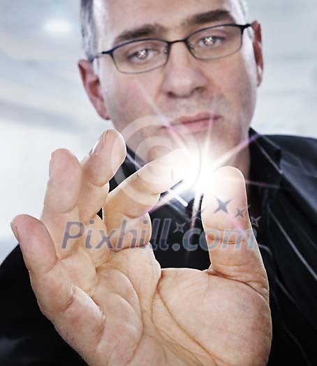 Businessman holding a bright sparkle