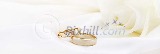 Wedding rings on white satin