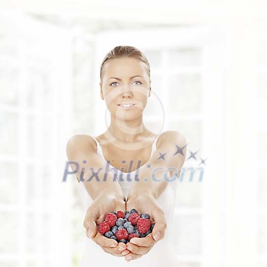 Woman offering a handful of berries Woman offering a handful of berries