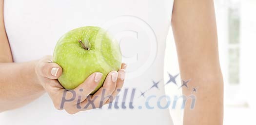 Woman holding an apple in her hand
