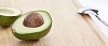 Half of avocado on a cutting board