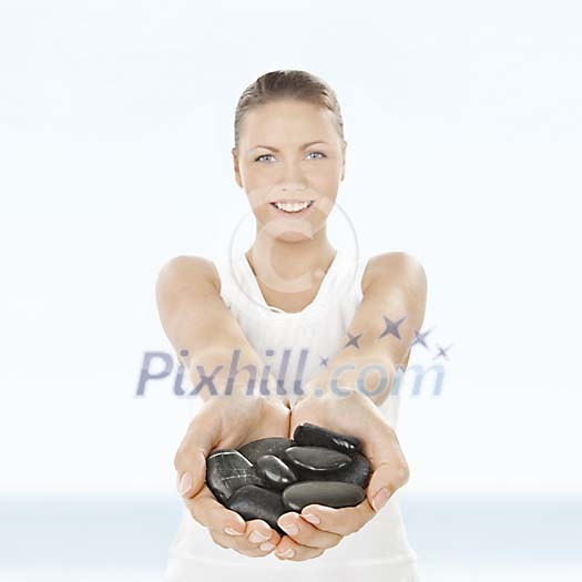 Woman holding lavastones in her hands