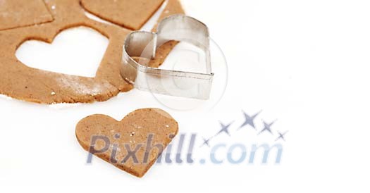 Making of gingerbread heart on a white background Making of gingerbread heart on a white background