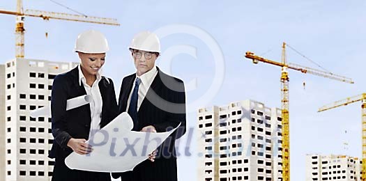 Man and a woman at the building site Man and a woman at the building site