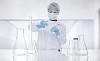 Laboratory assistant pouring fluid to a test tube