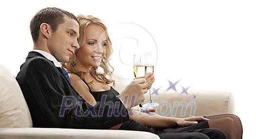 Couple toasting on the sofa