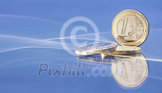 Euro coins on a blue background