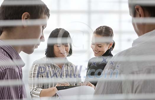 People behind window having a meeting