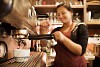 Waitress making coffee with machine