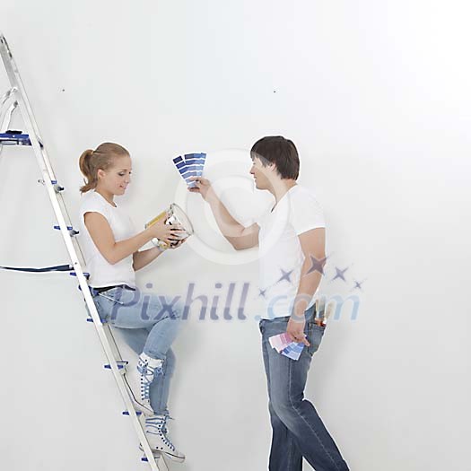 Couple choosing a clour for the wall