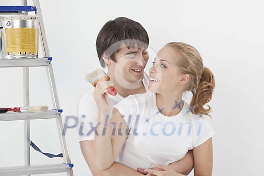 Couple having a hug before painting Couple having a hug before painting