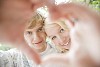 Couple looking through a heart shape made with their hands