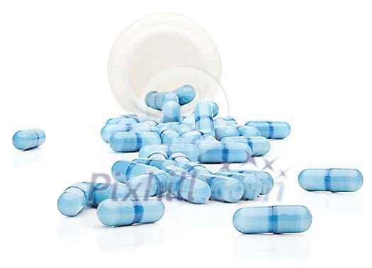 Clipped blue pills fallen out of the jar