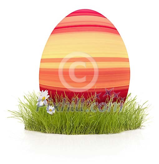 Striped easter egg on the grass Striped easter egg on the grass