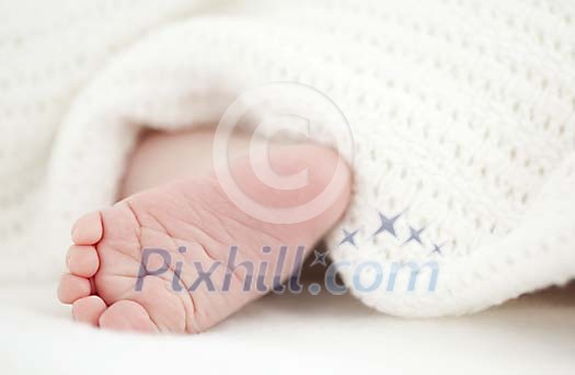 Baby foot under the blanket