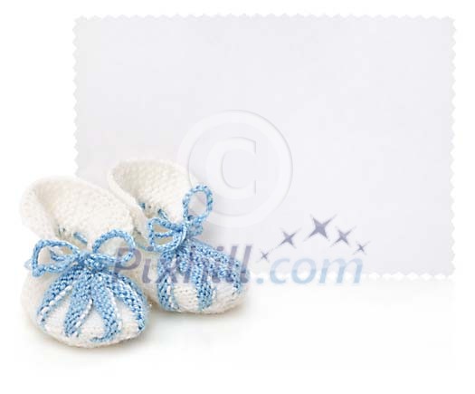 White empty card with baby boy shoes White empty card with baby boy shoes