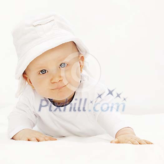 Baby with white hat looking at the camera Baby with white hat looking at the camera