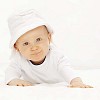 Baby with white hat looking at the camera