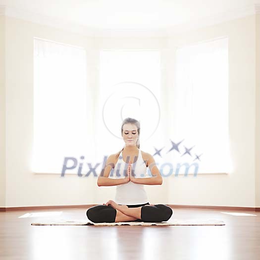 Woman meditating with hands on her chest