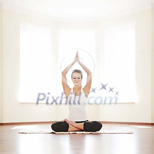 Woman meditating with hands above her head Woman meditating with hands above her head