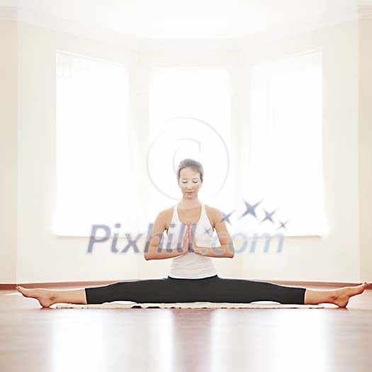 Woman doing splits and meditating