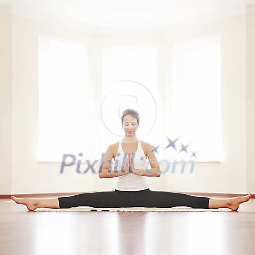 Woman doing splits and meditating Woman doing splits and meditating