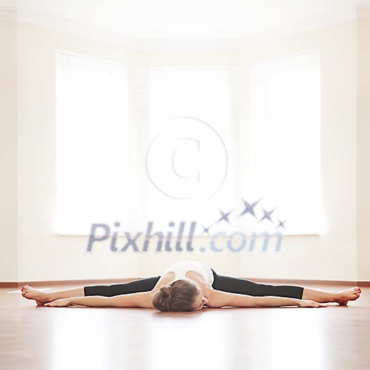 Woman doing splits and lying on the floor Woman doing splits and lying on the floor
