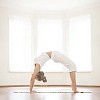 Woman balancing on her hands and feet