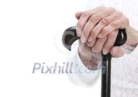 Old female hands holding a cane