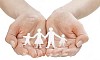 Female hands holding a paper cut out family