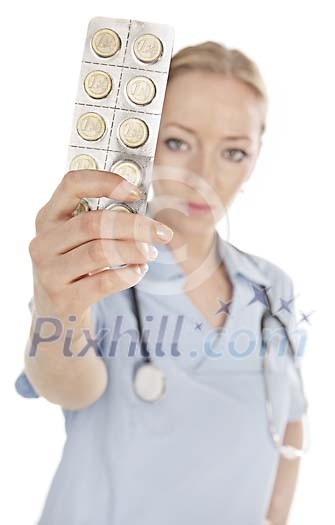 Female nurse holding a leaf of coin-pills