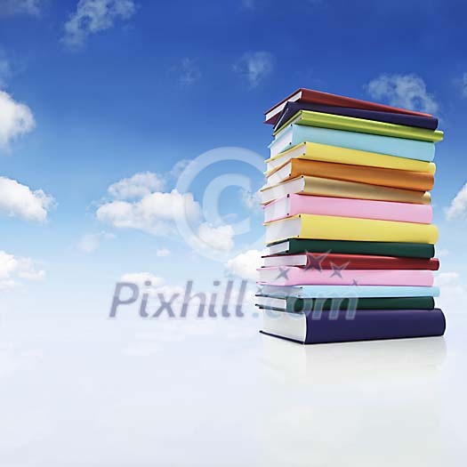 Pile of books surrounded by blue sky