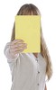Woman showing a book covering her face