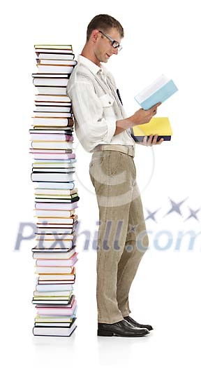 Clipped man reading next to a tower of books
