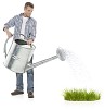 Man watering grass with giant watering can