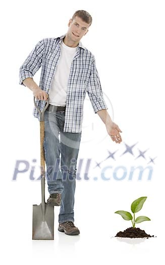 Man, shovel and a newly planted seedling with hand made clipping path Man, shovel and a newly planted seedling with hand made clipping path