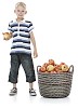 Boy eating apple from basket full of apples
