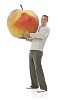 Man holding oversized apple