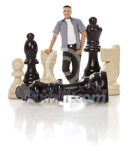 Clipped image of a man standing between oversized chess pieces
