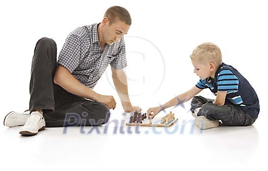 Father and son playing chess Father and son playing chess