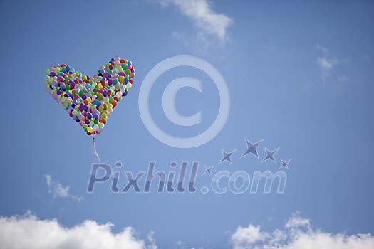 Balloons in the sky forming a heart shape